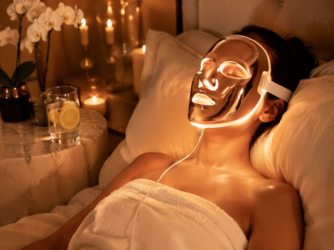 Woman wearing at-home LED mask for facial light therapy treatment at home